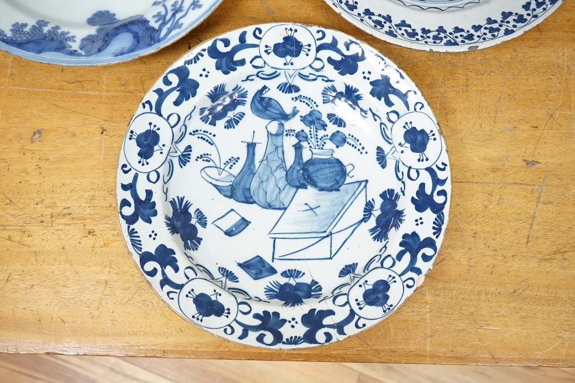 An 18th century English delftware ‘Chinese figures’ dish and two similar Delft dishes, largest 39cm diameter (3), largest 39cm
